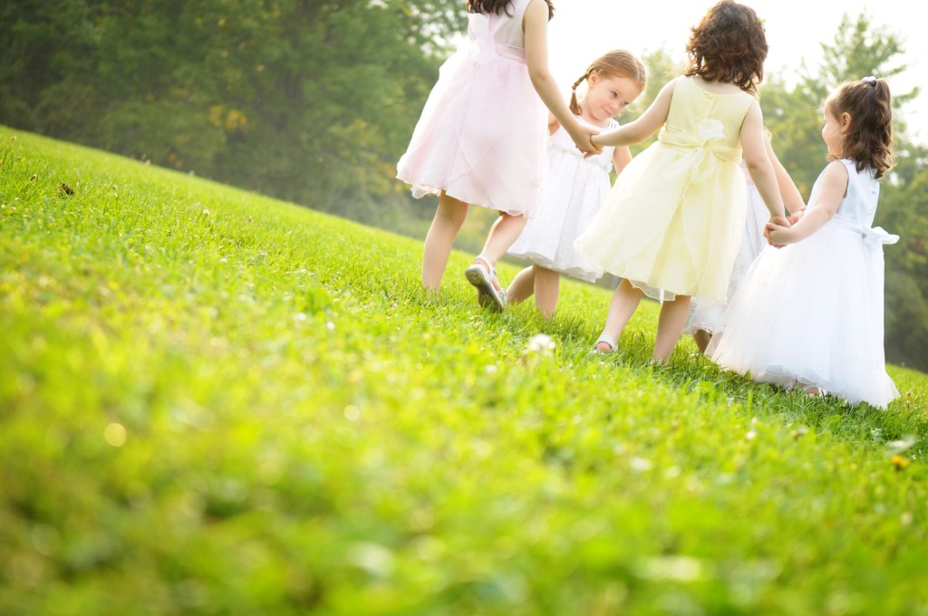 little-girls-wearing-dresses-and-spinning-in-a-circle-picture-id173025792