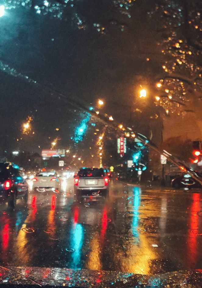 cars driving on asphalt road during rainy night